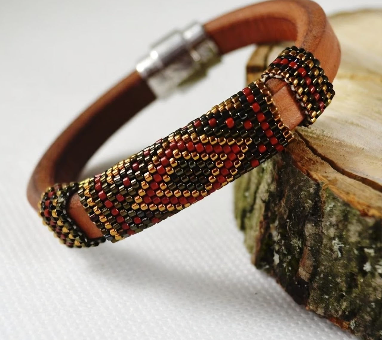 Brown leather bracelet with red, black, and gold Miyuki beadwork from the Zoé NFC collection